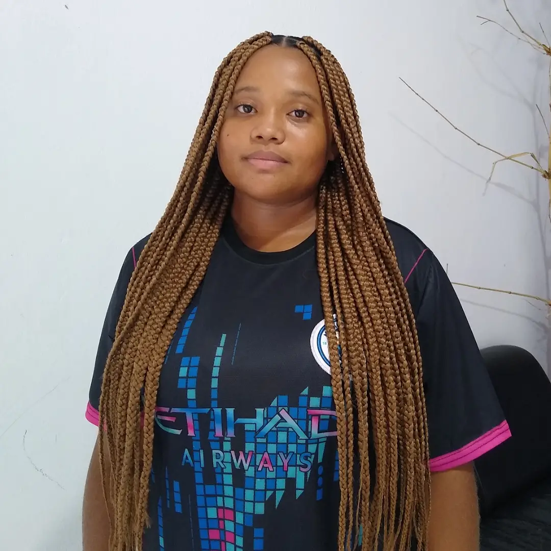 Box Braids longas em tom mel com divisão limpa